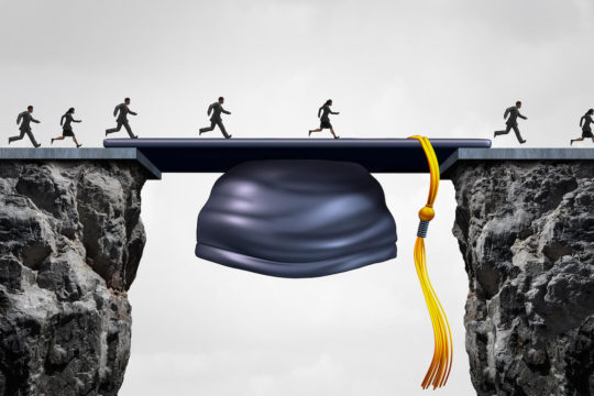 A graduation cap bridging the gap between two cliffs with people running across.